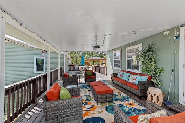 wooden terrace featuring an outdoor hangout area