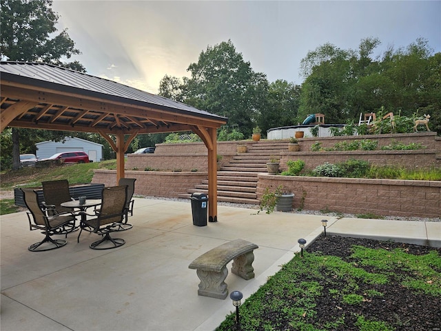 view of patio / terrace with outdoor dining area and a gazebo