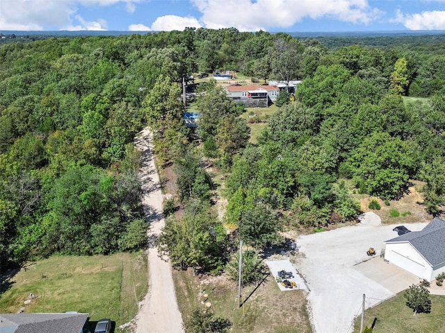 drone / aerial view featuring a wooded view