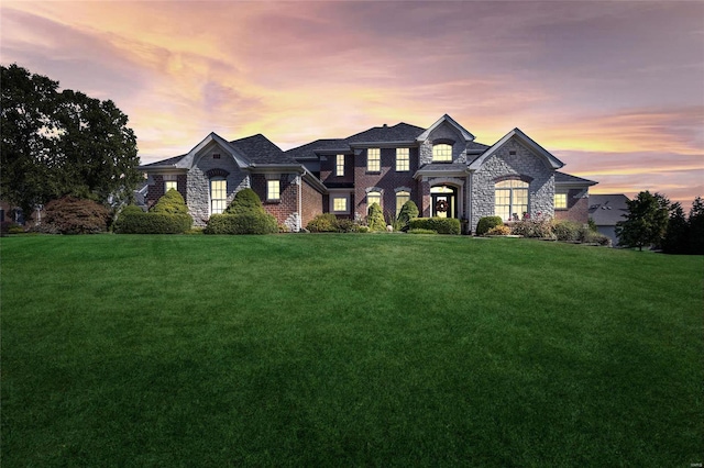 view of front of home featuring brick siding and a front yard