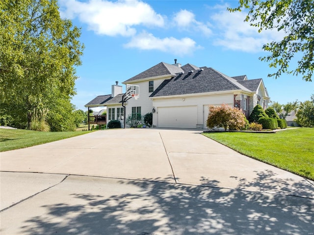 view of front of property featuring a garage and a front lawn