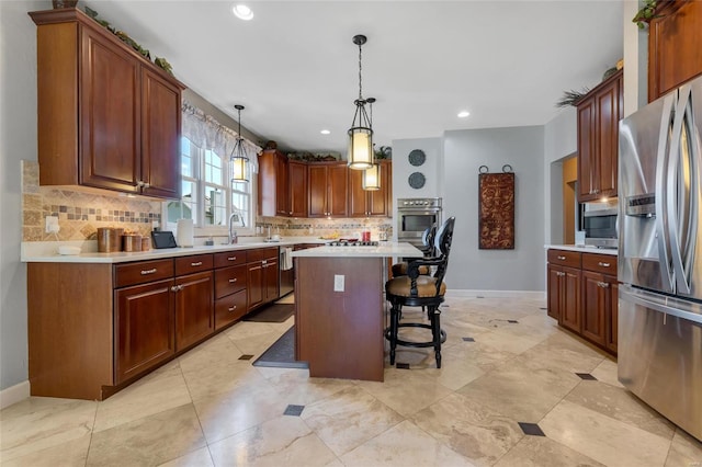 kitchen featuring a breakfast bar area, light countertops, decorative backsplash, appliances with stainless steel finishes, and a kitchen island