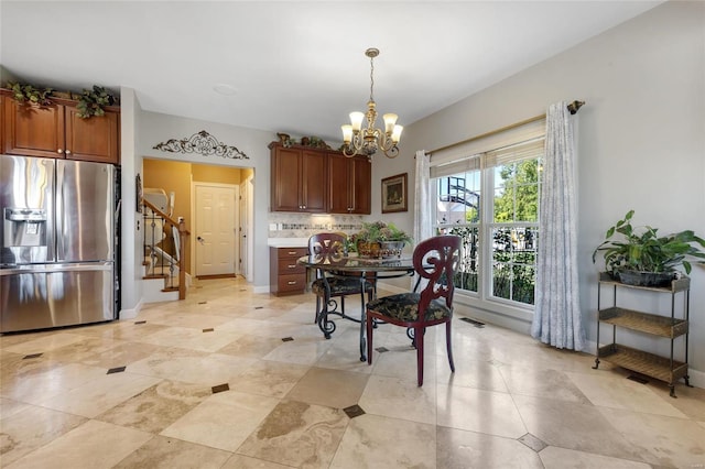 dining space with visible vents, stairs, baseboards, and a notable chandelier