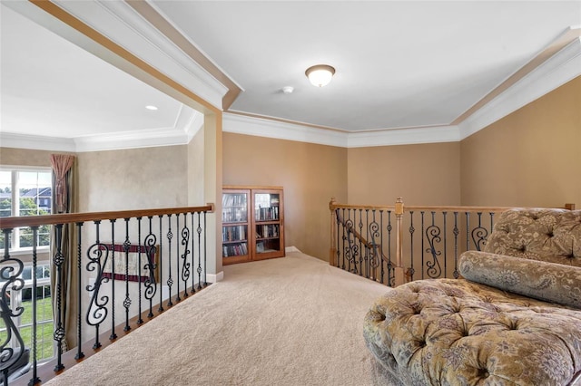 living area with ornamental molding, carpet flooring, and an upstairs landing