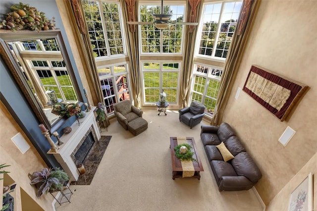 sunroom / solarium featuring plenty of natural light and ceiling fan