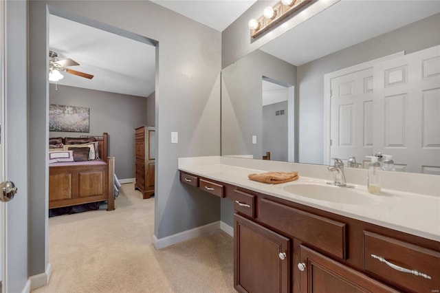 bathroom with ceiling fan, baseboards, and vanity