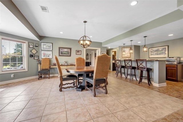 dining room with light tile patterned floors, baseboards, and visible vents