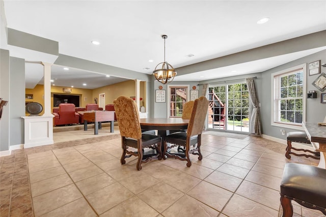 dining room featuring decorative columns, baseboards, light tile patterned flooring, a chandelier, and recessed lighting