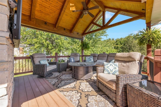 deck with a gazebo, an outdoor living space, and a ceiling fan