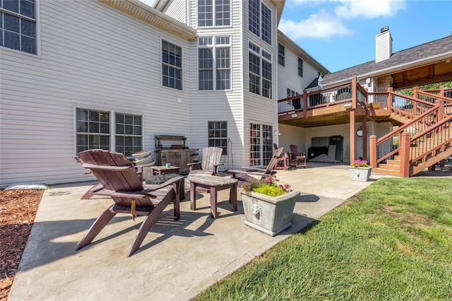 view of patio with stairs and a deck