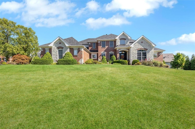 view of front of property featuring brick siding and a front yard