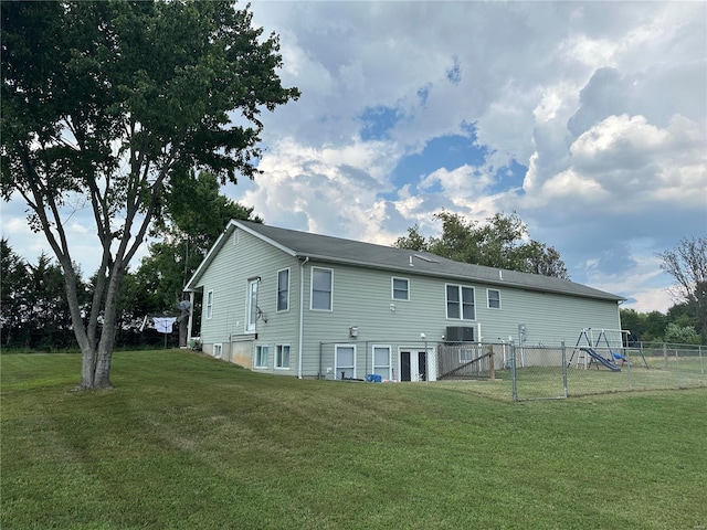 back of property featuring a yard and fence