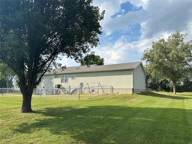 back of house with a yard and fence