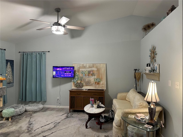living room with wood finished floors, ceiling fan, and vaulted ceiling