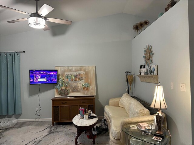 living room with lofted ceiling, ceiling fan, and light hardwood / wood-style flooring