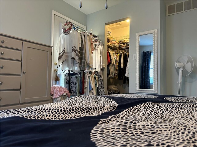 bedroom with a walk in closet and a closet