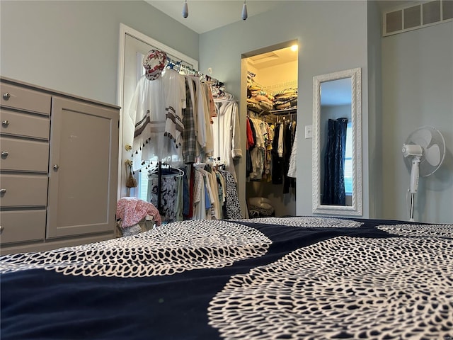 bedroom with visible vents, a closet, and a spacious closet