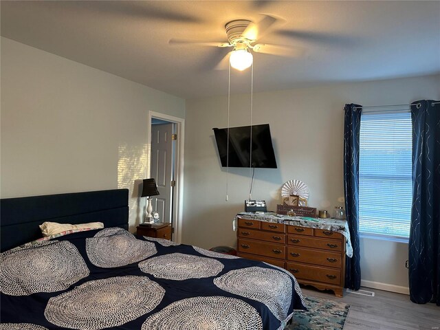 bedroom with light wood-type flooring and ceiling fan