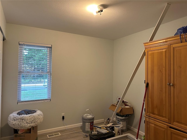 interior space featuring visible vents, baseboards, and wood finished floors