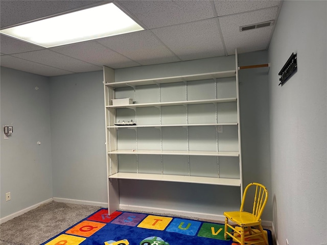 rec room featuring visible vents, carpet, baseboards, and a drop ceiling