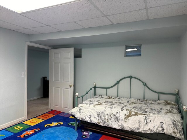 carpeted bedroom featuring a paneled ceiling