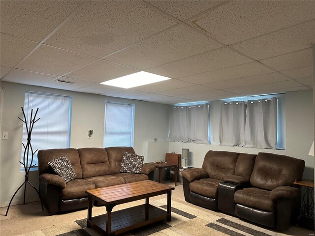 carpeted living room featuring a paneled ceiling