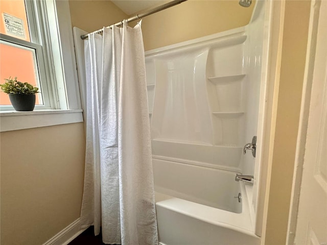 bathroom with shower / bath combo with shower curtain