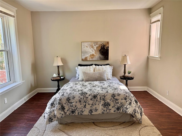 bedroom with dark wood-type flooring