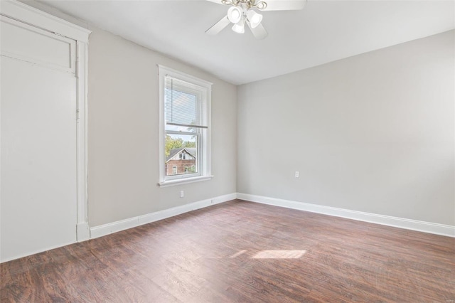 empty room with dark wood-type flooring and ceiling fan