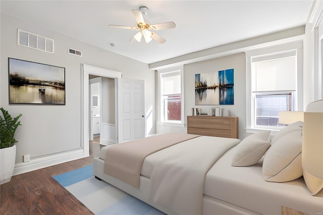 bedroom with dark hardwood / wood-style flooring and ceiling fan