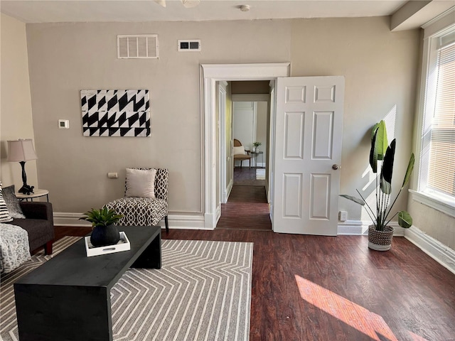 sitting room with dark hardwood / wood-style flooring