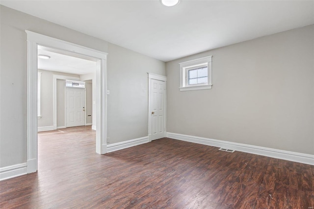 unfurnished room featuring dark hardwood / wood-style flooring