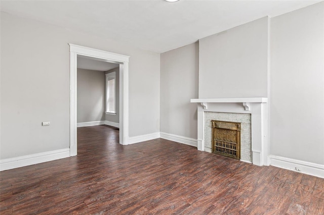 unfurnished living room featuring dark wood-type flooring