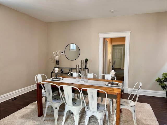 dining space with dark wood-type flooring