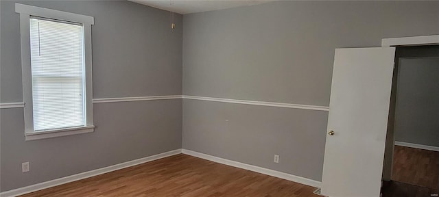 spare room with wood-type flooring