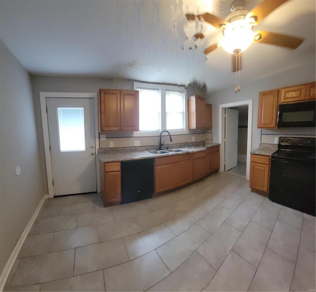 kitchen featuring black appliances, ceiling fan, light tile patterned floors, and sink