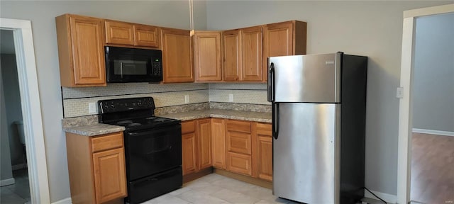 kitchen with black appliances, light tile patterned floors, and decorative backsplash