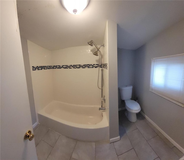 bathroom with tiled shower / bath, toilet, vaulted ceiling, and tile patterned floors