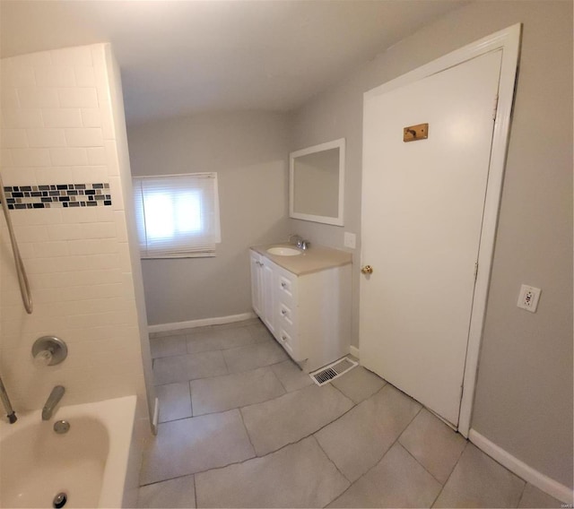 bathroom with tiled shower / bath, vanity, and tile patterned floors