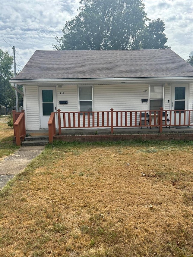 view of front of home featuring covered porch and a front yard