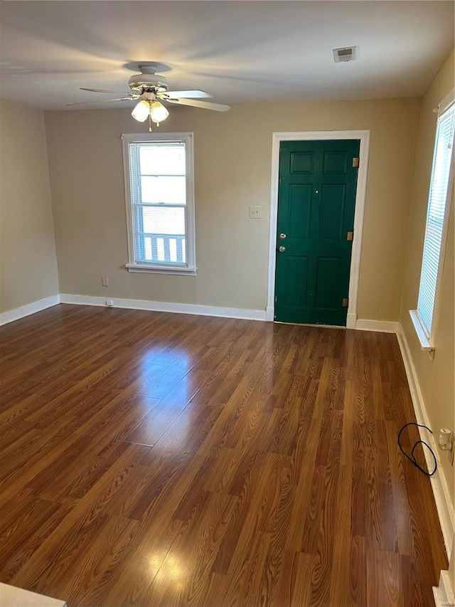 foyer entrance with ceiling fan and dark hardwood / wood-style flooring