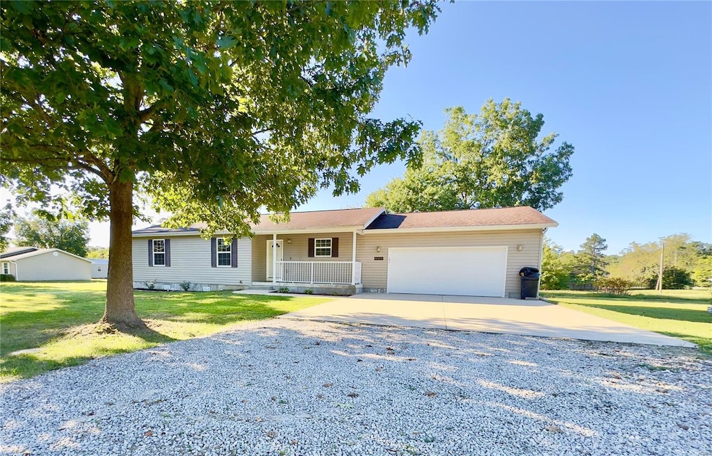 ranch-style home featuring a front yard and a garage