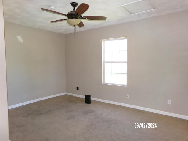 carpeted empty room featuring ceiling fan