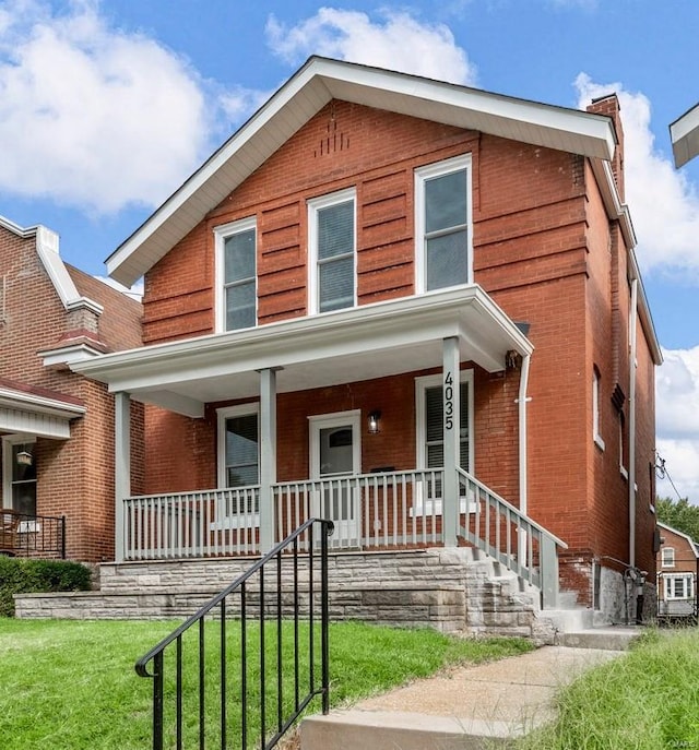 view of front facade with a porch and a front lawn