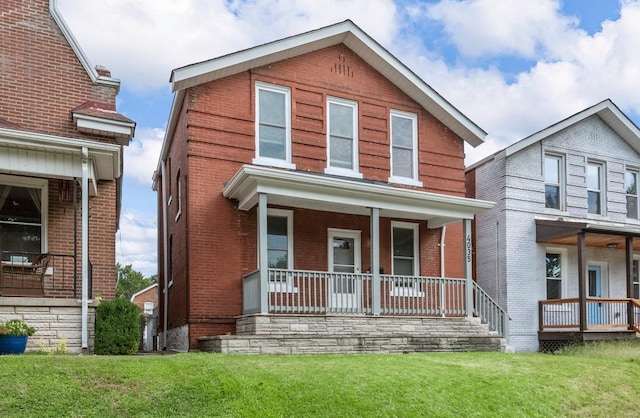 view of front of home with a porch and a front lawn