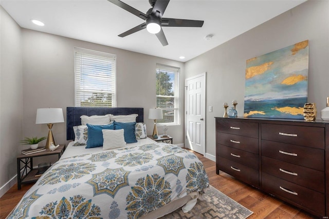 bedroom with ceiling fan and hardwood / wood-style flooring