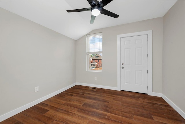 empty room featuring lofted ceiling, ceiling fan, and dark hardwood / wood-style floors