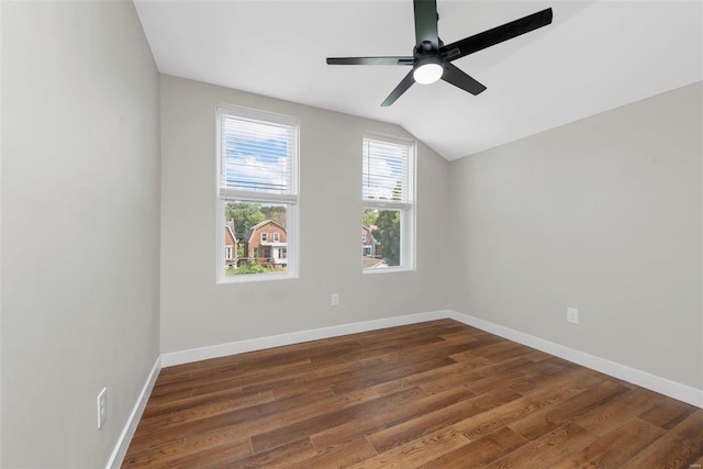 spare room featuring lofted ceiling, ceiling fan, and dark hardwood / wood-style flooring