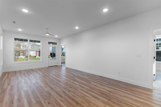 unfurnished living room with ceiling fan and light hardwood / wood-style floors