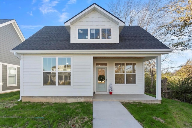 bungalow featuring a porch and a front lawn